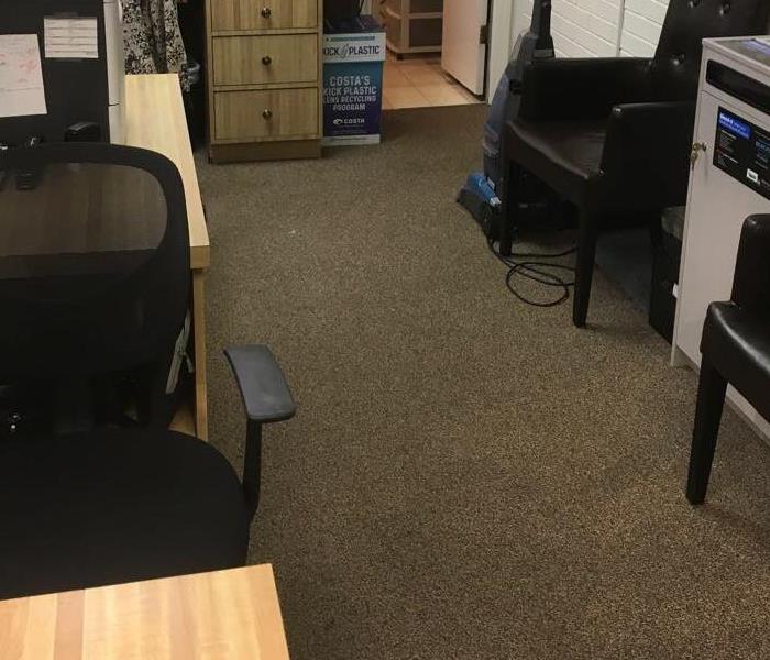 office space with desk and wet carpet