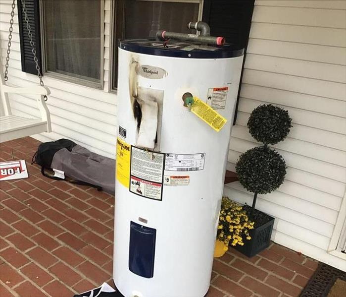 water heater with black scorched fire damage
