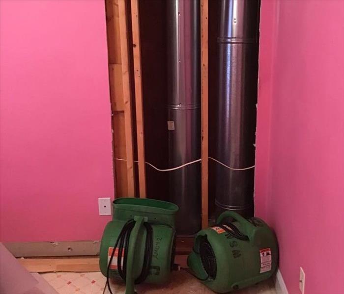 bright bubblegum pink room with corner cut with green airmovers