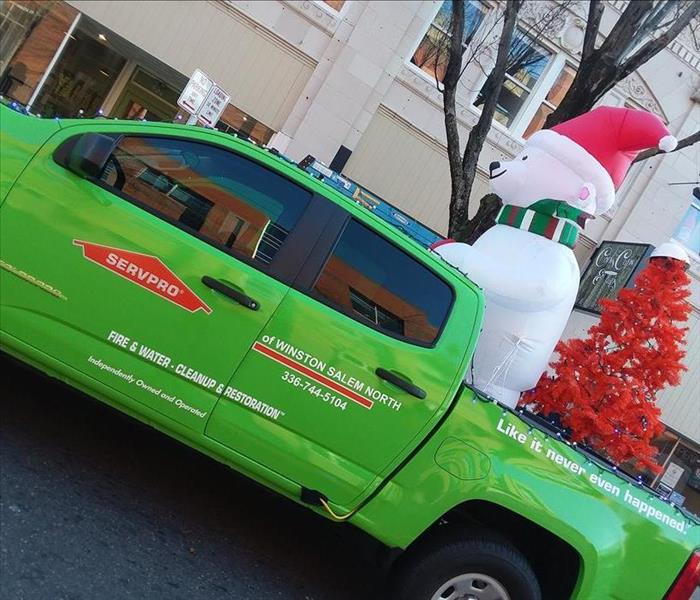 Green SERVPRO Truck with Blow up White Christmas Bear
