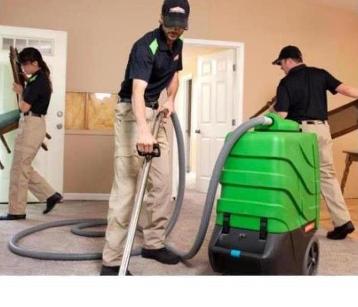 SERVPRO cleaning crew working on cleaning a carpet 