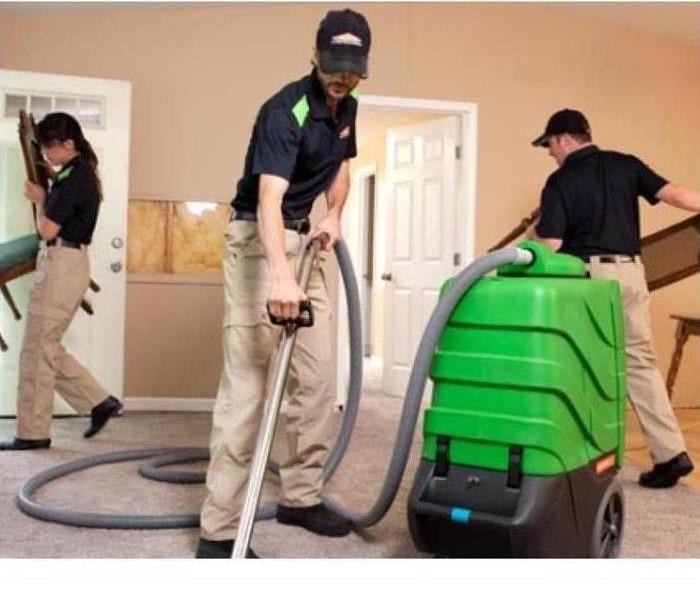 SERVPRO crew working to clean a carpet using SERVPRO equipment 